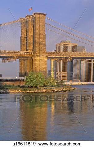 Stock Photo - Brooklyn Bridge over the East River at Sunrise, NY. Fotosearch