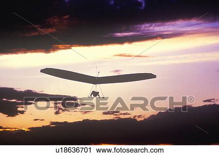 Solar Sailing Hang Gliding in sunset silhouette View Large Photo Image Stock Image - Solar Sailing Hang Gliding in sunset silhouette. Fotosearch