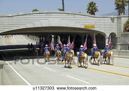 Stock Image - Cowboys marching with American Flags. Fotosearch