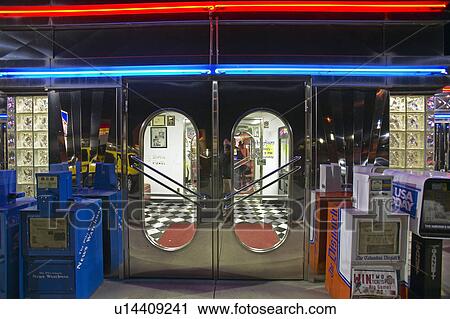 Stock Image - Front entrance to Diner at night. Fotosearch
