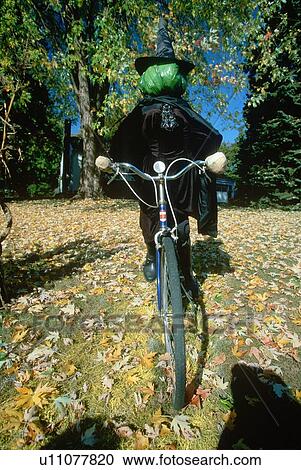Stock Image - Halloween Witch on Bicycle. Fotosearch