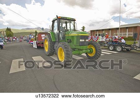 Tractor leading the Fourth of July parade down main street View Large Photo Image Stock Image - Tractor leading the Fourth of July parade down main street. Fotosearch