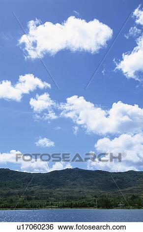 Stock Photograph - A Blue Sky And An Island. Fotosearch