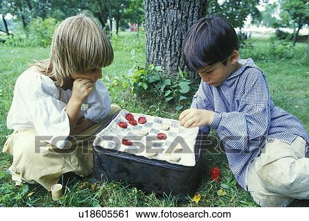 Boys playing checkers in Historical Revolutionary War reenactment View Large Photo Image Stock Image - Boys playing checkers in Historical Revolutionary War reenactment. Fotosearch