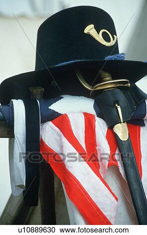 Stock Image - U. S. Calvary hat, sword and flag from American Civil War. Fotosearch