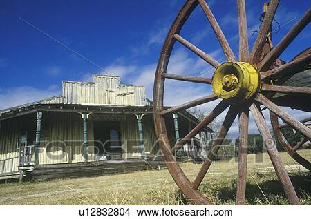 Picture - Wagon wheel and old building in South TX ghost town. Fotosearch