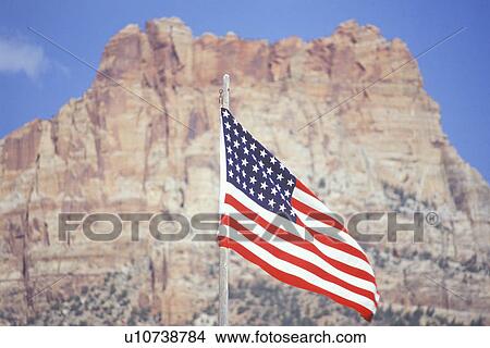 Picture - American Flag Flying in front of Mountain. Fotosearch