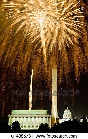 Stock Image - Fireworks exploding over the Lincoln Memorial, Washington Monument and U. S. Capitol, Washington D. C.. Fotosearch