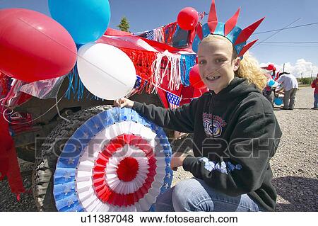 Stock Photo - Teenage girl decorating a car in red, white & blue. Fotosearch