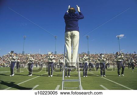Stock Photography - College band performing at Half time during football game. Fotosearch