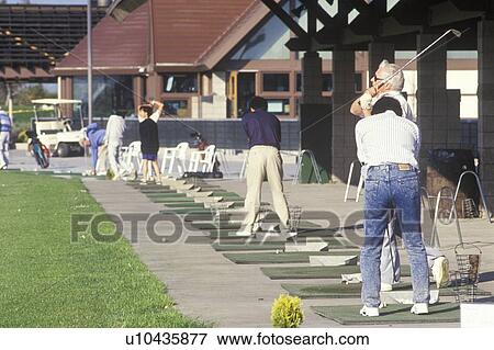 Golfers lined up on putting range, Golf Club View Large Photo Image Stock Photo - Golfers lined up on putting range, Golf Club. Fotosearch