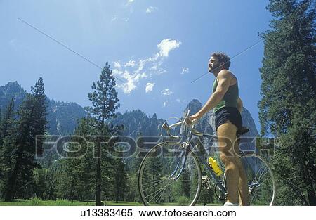 Man riding road bicycle in forest View Large Photo Image Stock Photography - Man riding road bicycle in forest. Fotosearch