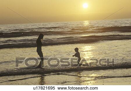 people on beach at sunset View Large Photo Image Stock Photography - people on beach at sunset. Fotosearch