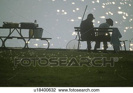 Silhouette of 2 fishermen on bench with poles View Large Photo Image Stock Image - Silhouette of 2 fishermen on bench with poles. Fotosearch