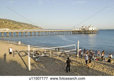 Stock Photo - Volleyball game near pier. Fotosearch