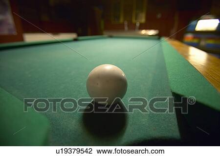 White pool ball lit by electric lights in a restaurant and bar View Large Photo Image Stock Image - White pool ball lit by electric lights in a restaurant and bar. Fotosearch
