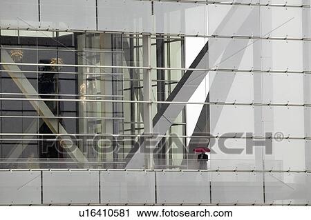 Stock Image - A solo figure holding an umbrella. Fotosearch
