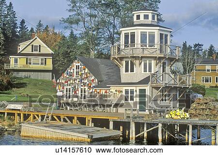 Stock Image - Floats from fishing nets hang on the side of a lighthouse. Fotosearch