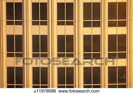 Stock Photo - Sunset in windows of office building. Fotosearch