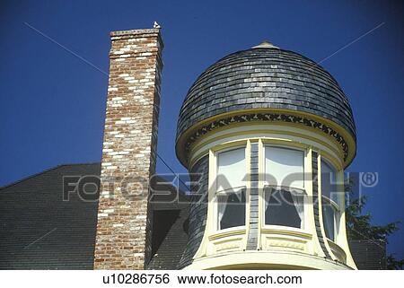 Stock Photograph - Turret next to chimney in house. Fotosearch