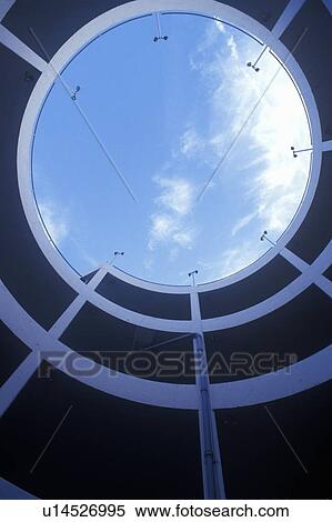 Stock Photography - View up through circular stairway and blue sky at a sports stadium. Fotosearch