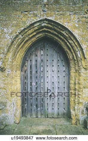 Heavy wooden door under archway at a church View Large Photo Image Stock Photo - Heavy wooden door under archway at a church. Fotosearch