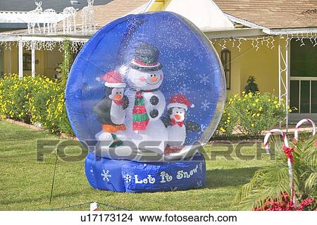 Picture - Giant faux crystal ball with Christmas snowman decorations. Fotosearch
