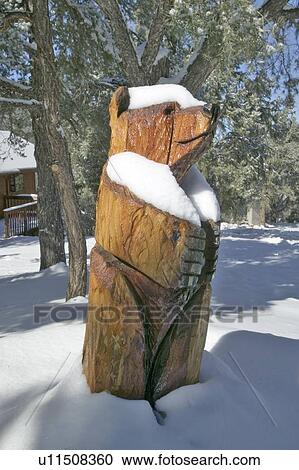 Stock Image - Snow on wooden Bear. Fotosearch