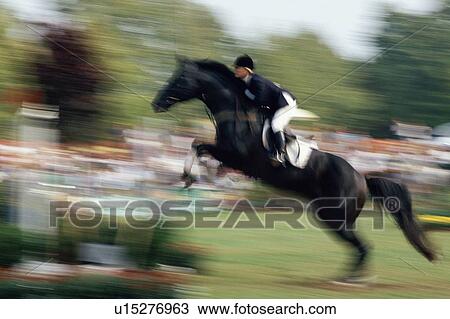 Stock Image - Horse jumping at an equestrian competition. Fotosearch