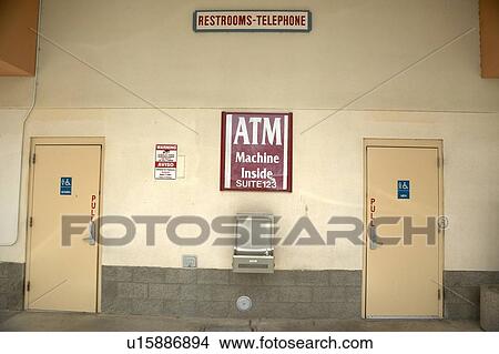 Signs directing people to ATM machine and restrooms View Large Photo Image Picture - Signs directing people to ATM machine and restrooms. Fotosearch