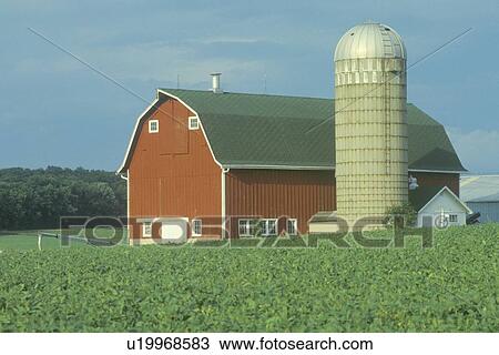 Stock Image - Farm with red barn and grain silo. Fotosearch