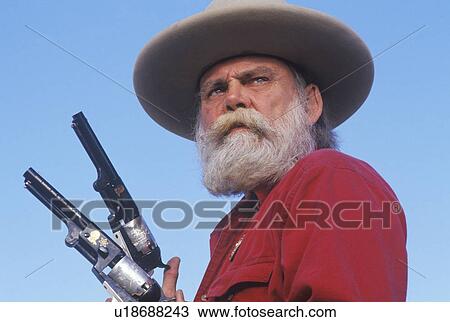 Old West gunslinger drawing guns during historical reenactment View Large Photo Image Stock Image - Old West gunslinger drawing guns during historical reenactment. Fotosearch