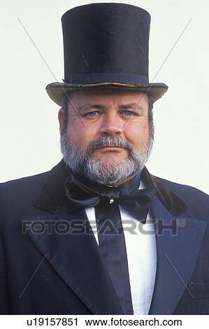 Stock Image - Portrait of Old West cowboy with top hat and mutton chop whiskers. Fotosearch