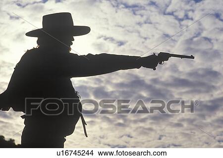Silhouette of Cowboy aiming pistol View Large Photo Image Picture - Silhouette of Cowboy aiming pistol. Fotosearch