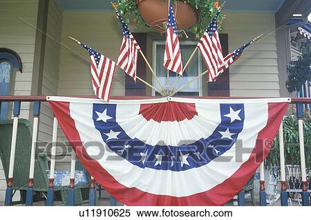 Stock Photography - American Flags and bunting Hung on Porch of House. Fotosearch