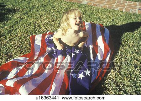 Stock Image - Little Girl Wrapped in American Flag, United States . Fotosearch