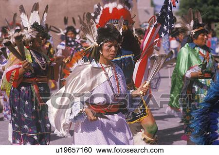 Stock Image - Native American woman in full costume performing Corn Dance ceremony. Fotosearch