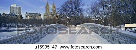 Stock Photo - Panoramic view of bridge over frozen pond in Central Park, Manhattan, New York City. Fotosearch
