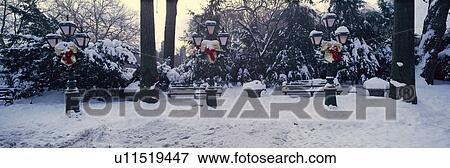 Stock Photo - Panoramic view of Christmas wreath on lampposts in Central Park, Manhattan, New York City. Fotosearch