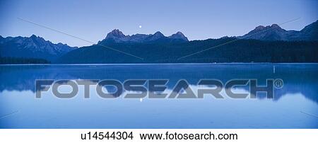 Picture - Moonset at sunrise over Redfish Lake and Sawtooth Mountains. Fotosearch