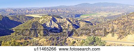 Stock Photograph - Panoramic look at Highway 33 overview of Cuyama Valley with Green Field. Fotosearch