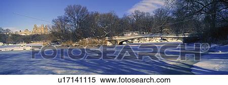 Stock Photography - Panoramic view of bridge over frozen pond in Central Park, Manhattan, & NY. Fotosearch