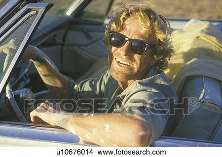 A man with sunglasses driving View Large Photo Image Picture - A man with sunglasses driving. Fotosearch