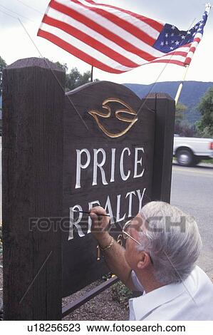A sign painter touching up his work View Large Photo Image Stock Image - A sign painter touching up his work. Fotosearch