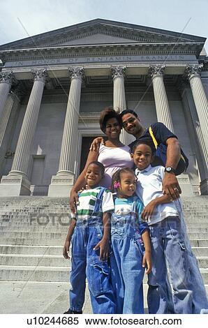 Stock Photography - Family of tourists on the steps of the Benjamin Franklin Institute. Fotosearch