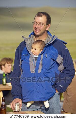 Father with baby in pouch View Large Photo Image Stock Photo - Father with baby in pouch. Fotosearch