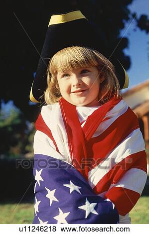 Stock Photo - Little girl wrapped in American flag wearing three cornered hat . Fotosearch