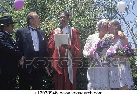Middle aged bride and groom at an outdoor wedding ceremony View Large Photo Image Stock Photograph - Middle aged bride and groom at an outdoor wedding ceremony. Fotosearch