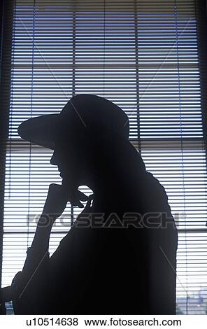 Stock Photo - Silhouette Of A Woman Wearing A Hat. Fotosearch