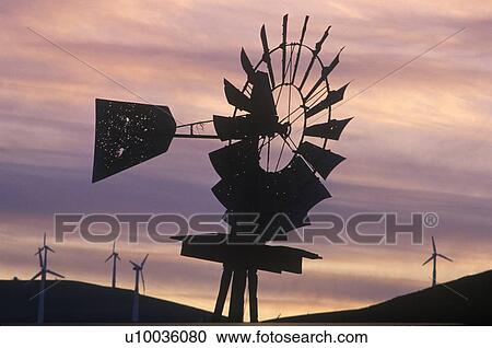 Stock Image - Windmill and wind turbines at sunset in Livermore. Fotosearch
